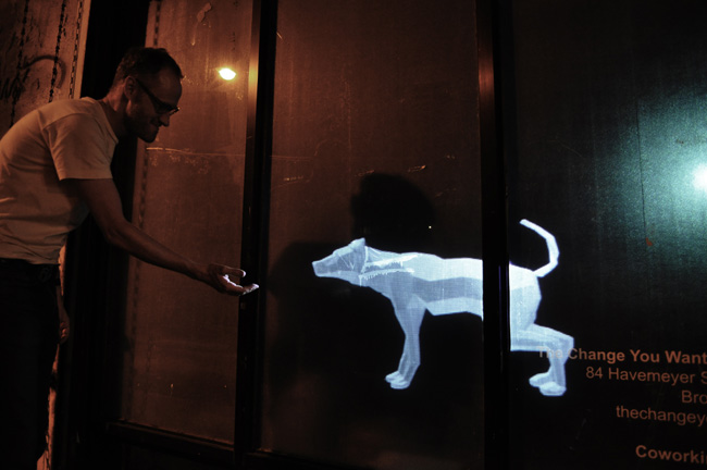 Figure 4. A user interacting with Sniff in a storefront installation of the work